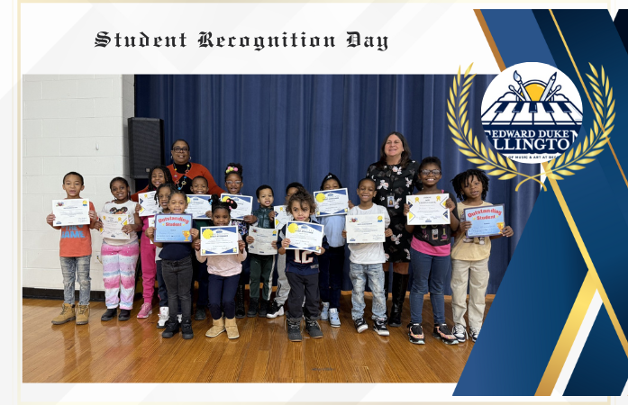  Second grade student holding their certificate for their great achievements for the second quarter.